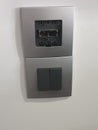 black double switch with gray plastic faceplate, partially damaged. Royalty Free Stock Photo