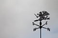 Black dragon wind vane against the sky. Weather vane. Compass points Royalty Free Stock Photo