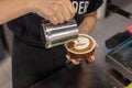 Pouring milk into a hot chocolate cocoa drink