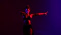 Black dressed and braided hair woman dancehall music style dancing on a blue and red background