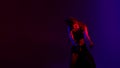 Black dressed and braided hair woman dancehall music style dancing on a blue and red background