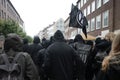 Black dressed protesters on a demonstration march through the streets of Lubeck against German politics and for accommodation of