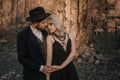 Black dressed wedding couple in rock. In love concept. Newly weds happy couple celebrating love.