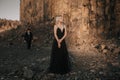 Black dressed wedding couple in rock. In love concept. Newly weds happy couple celebrating love.