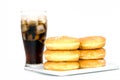 Black drink (cola) and donuts and sugar over lettuce over white Royalty Free Stock Photo