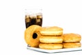 Black drink (cola) and donuts and sugar over lettuce over white Royalty Free Stock Photo