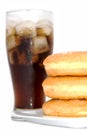 black drink (cola) and donuts and sugar over lettuce over white Royalty Free Stock Photo