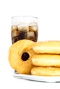 Black drink (cola) and donuts and sugar over lettuce over white Royalty Free Stock Photo