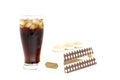 Black drink (cola) and sugar over lettuce over white background Royalty Free Stock Photo