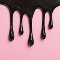 Glossy Black Drips Over Pink Velvet Background Royalty Free Stock Photo