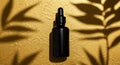Black dropper bottle on a textured golden surface. Shadows of leaves cast on the Royalty Free Stock Photo