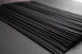 Black dry raw noodles on dark background Royalty Free Stock Photo