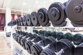 Black dumbbell in fitness center room for background