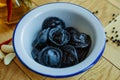Black dumplings in a white plate on the table. Royalty Free Stock Photo
