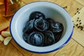 Black dumplings in a white plate on the table. Royalty Free Stock Photo