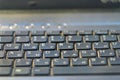 Black dusty laptop keyboard closeup