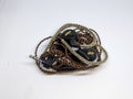 A black in ear mornitor or IEM with brown cable and white background