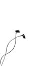 Black earphones lying on the white background. Modern music concept. Audio technology Royalty Free Stock Photo