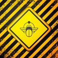 Black Egyptian Scarab icon isolated on yellow background. Winged scarab Beetle and sun. Warning sign. Vector