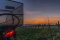 Black electric bicycle with sunset on light green meadow in spring evening