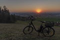 Black electric bike on ski slope in Budweis city with sunset Royalty Free Stock Photo