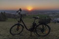Black electric bike on ski slope in Budweis city with sunset Royalty Free Stock Photo