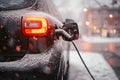 Black electric car EV charging during the winter Royalty Free Stock Photo