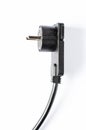 Black electric extension cord on a white background. Closeup