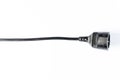 Black electric extension cord on a white background. Closeup. Copy space