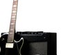 Black electric guitar with guitar amplifier on a white background Royalty Free Stock Photo