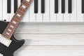 Black Electric Guitar with Piano Keys on a Wooden Table. 3d Rendering Royalty Free Stock Photo