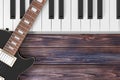 Black Electric Guitar with Piano Keys on a Wooden Table. 3d Rendering Royalty Free Stock Photo