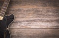 Black electric guitar on a rustic wooden background Royalty Free Stock Photo