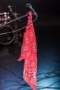 Black electric microphone with red scarf on empty stage Royalty Free Stock Photo