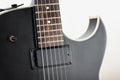 Black electric rock guitar with humbucker pickup close up macro shot