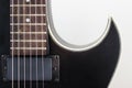 Black electric rock guitar with humbucker pickup close up macro shot Royalty Free Stock Photo