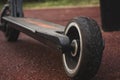 black electric scooter standing on the rubber pad in the park, rear view Royalty Free Stock Photo