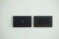 Black electrical outlet and inserts the antenna cable to the TV outlet Royalty Free Stock Photo