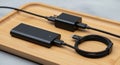 A rectangular power bank a USB wall charger and a coiled USB C Royalty Free Stock Photo