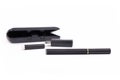 Black electronic cigarette stick with USB charger, e-liquid cartridge and case in blurry background