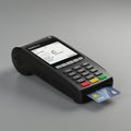 A black electronic payment terminal is displayed on a gray surface. It features a Royalty Free Stock Photo