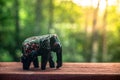 Black elephant figurine made of wood on a blurry background