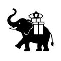 Black silhouette of an elephant carrying two gift boxes on its back in a vector illustration Royalty Free Stock Photo