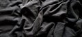 Black embossed fabric in pleats