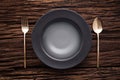 Black empty bowl fork spoon on wooden table background Royalty Free Stock Photo