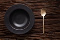 Black empty bowl spoon on wooden table background Royalty Free Stock Photo