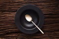 Black empty bowl spoon on wooden table background Royalty Free Stock Photo