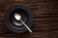 Black empty bowl spoon on wooden table background Royalty Free Stock Photo