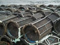 Black empty fish and crab traps ashore, Water in the background. Fishing industry