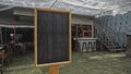 Black empty old chalk board standing indoors Royalty Free Stock Photo